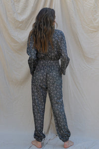 back of jumpsuit has elastic at the waistband and dual pockets on bum