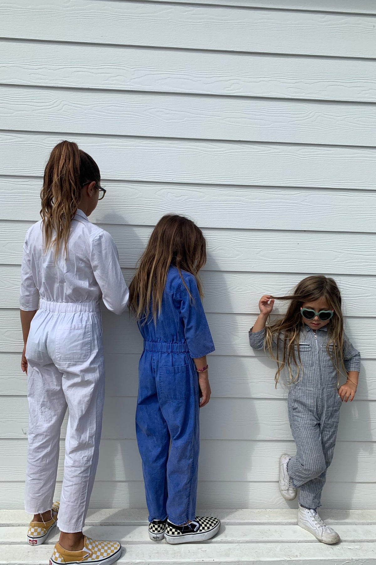 (from left to right) little palmetto station suit in white, palace blue, and stormy stripe