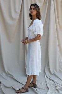 white gauze midi dress with puff sleeves that end at the elbow